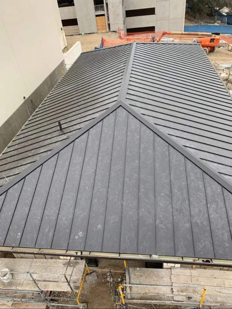 Commercial metal roof construction with crane equipment in Damascus